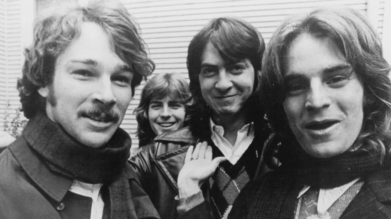 A candid camaraderie moment behind the music.